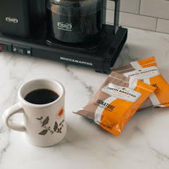 Close-up of a single Fresh Roasted Coffee 1.75 oz packet, illustrating pre-measured convenience