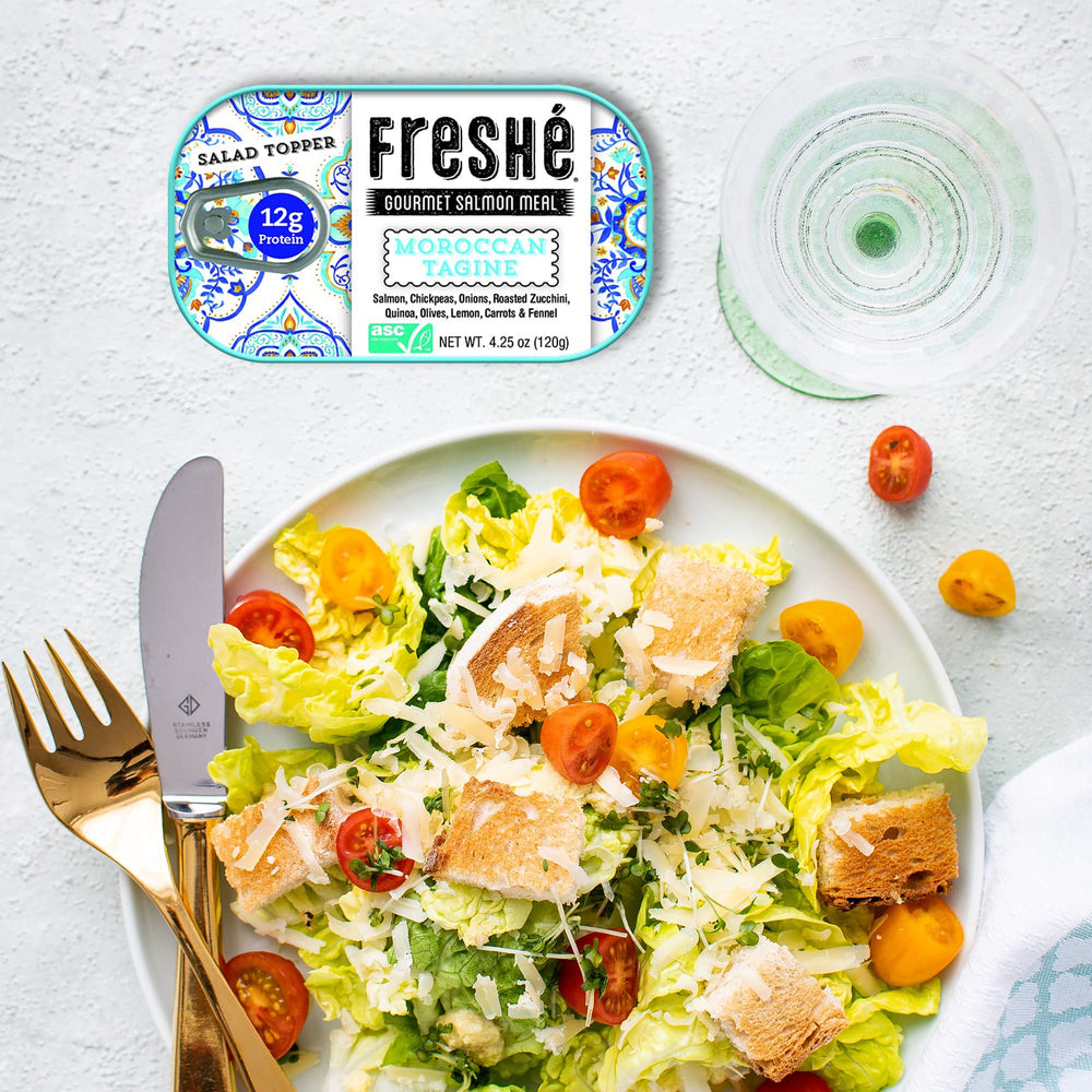 Freshé tin in hand for scale showing compact size and travel convenience