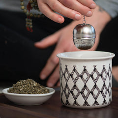 Jar of oil infusion with Frontier Co-op red raspberry leaf showing DIY body-care potential