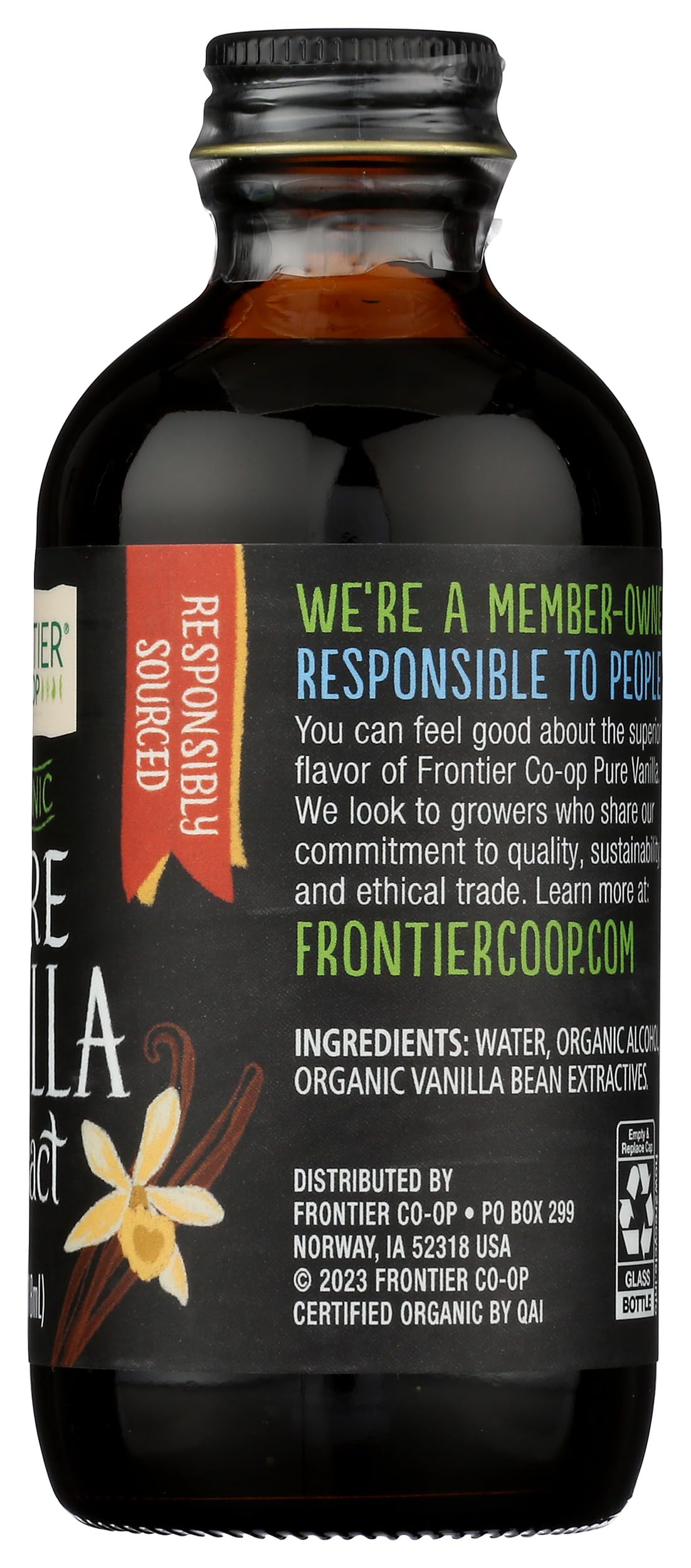 Hand holding Frontier Co-op 4 fl oz bottle to show compact kitchen-friendly size