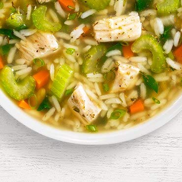 Frontier Soups bowl on a table with spoon and napkin illustrating convenient homestyle serving