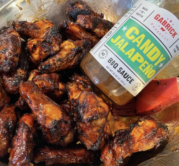 Bottle beside a ruler for scale representing Gabrick Barbecue 20 oz size and convenient portioning benefit