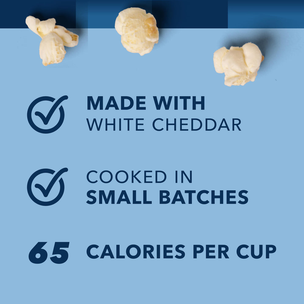 Closeup of Garrett Popcorn white cheddar kernels highlighting crunchy texture and cheese coverage for savory appeal