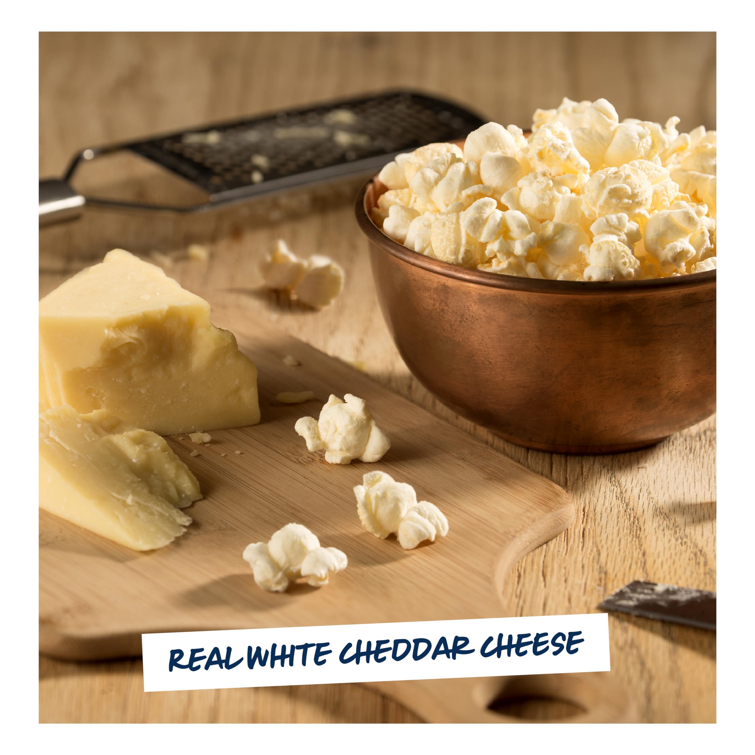 Hand holding a 5.0 oz Garrett Popcorn white cheddar bag to demonstrate true scale and single‑serve convenience
