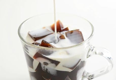Generic brand coffee jelly with milk being poured, demonstrating creamy topping option