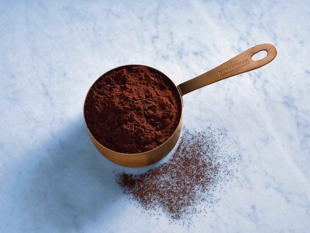 Ghirardelli cocoa scooped into a bowl ready for baking to ensure consistent results