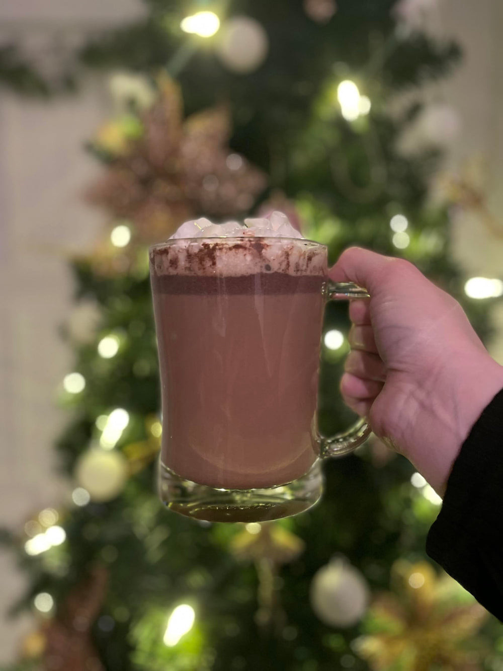 Ghirardelli powder scooped in hand illustrating easy measuring and versatile use
