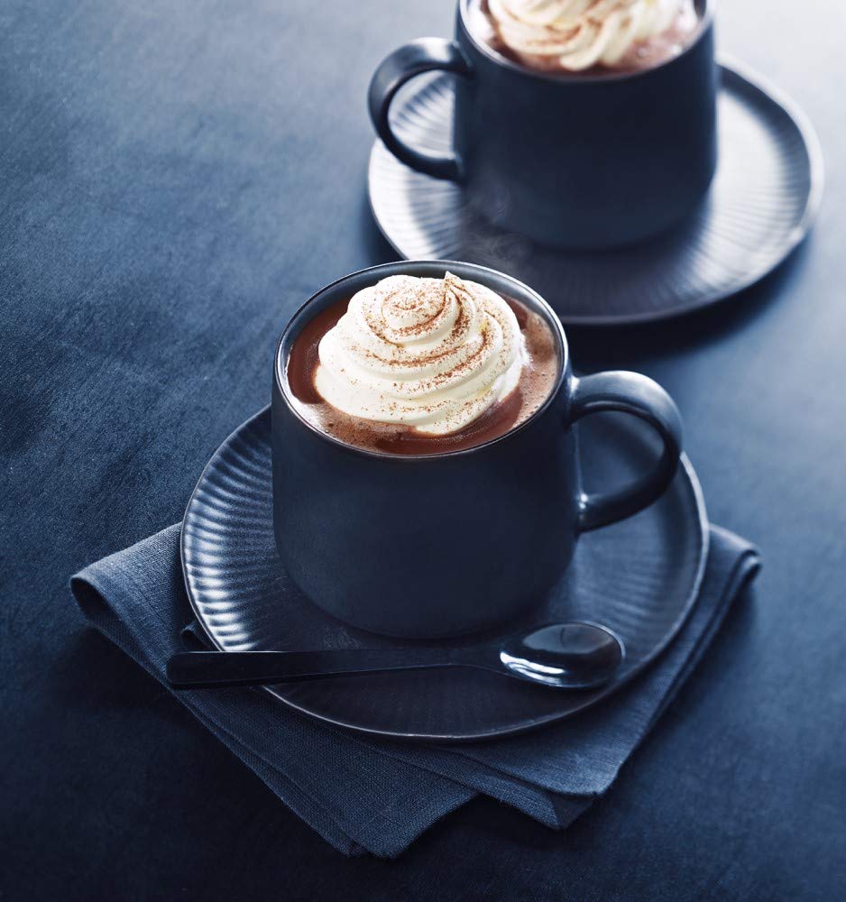 Ghirardelli prepared cup in cozy setting showcasing warm rich chocolate enjoyment