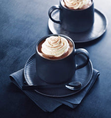 Ghirardelli prepared cup in cozy setting showcasing warm rich chocolate enjoyment