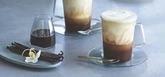 Ghirardelli bottle beside measuring cup showing 87.3-ounce scale and commercial portioning