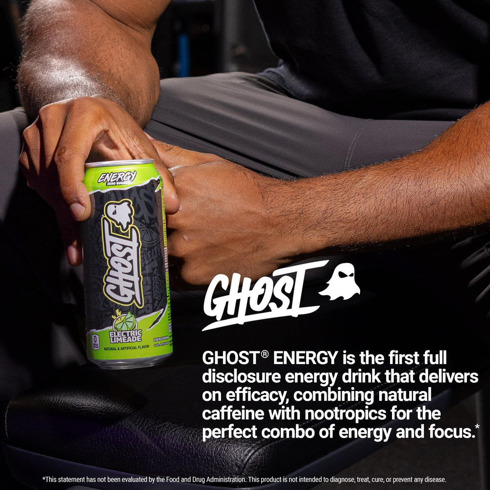 GHOST can on a desk next to laptop showing focus and productivity