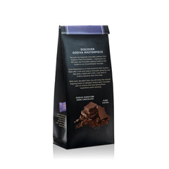 Close-up of an individually wrapped Godiva Masterpiece piece highlighting glossy dark shell