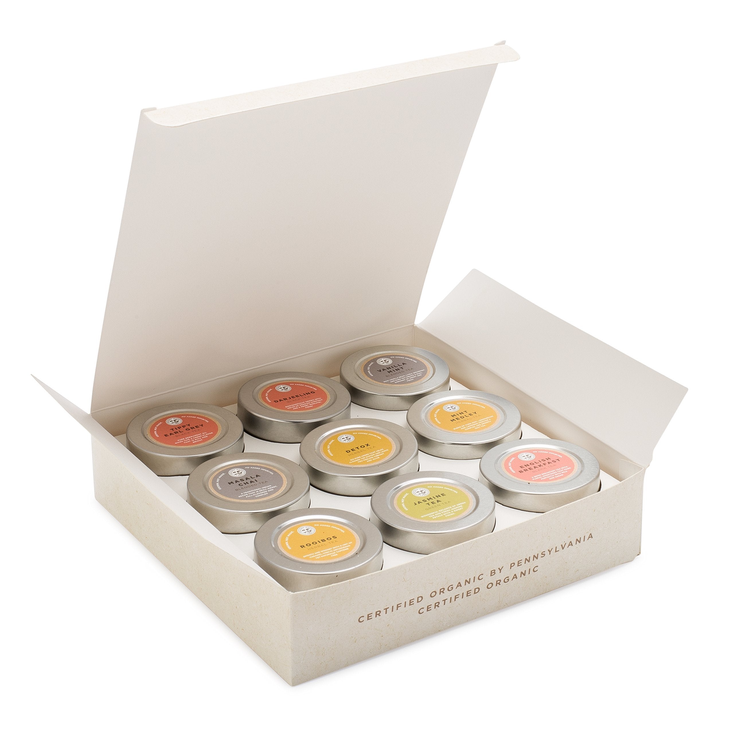 Golden Moon Tea open tins top view displaying distinct leaf textures