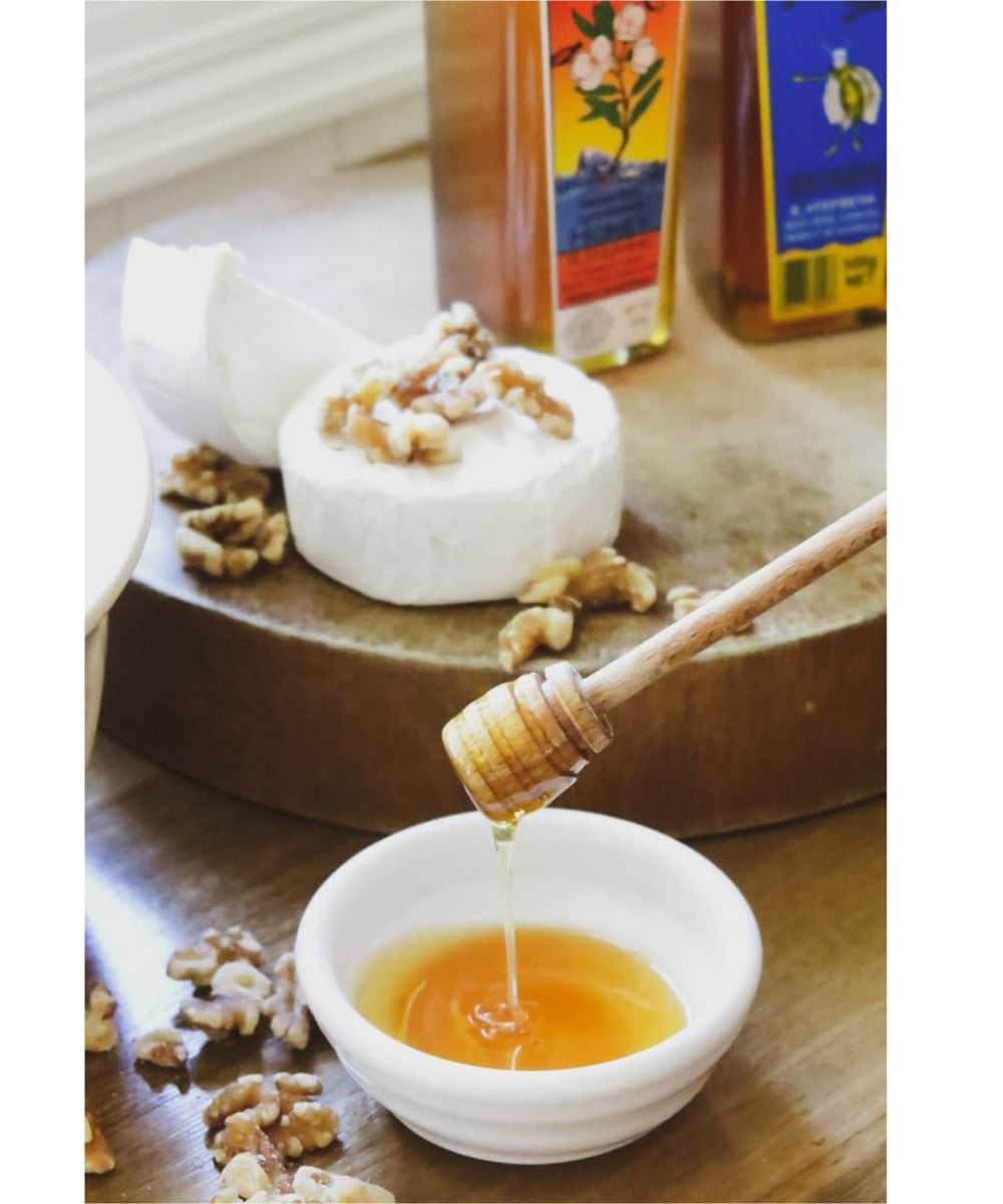 Golden Nectar honey pouring from spoon to show silky consistency and rich aroma benefit