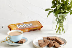 Good Aussie Tim Tam beside coffee cup as a pairing idea for enhanced flavor experience