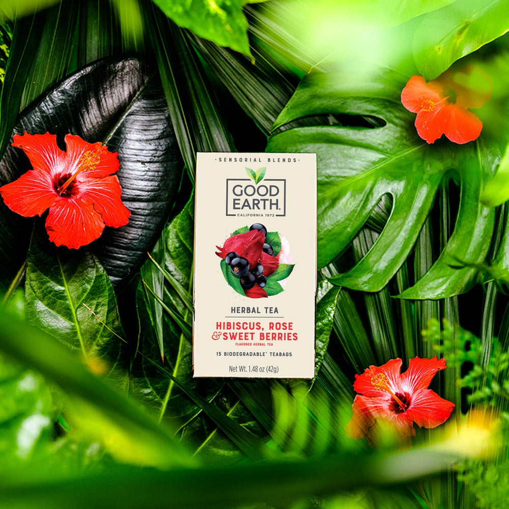 Good Earth cup lifestyle shot pouring brewed tea over ice showcasing vibrant color and refreshment