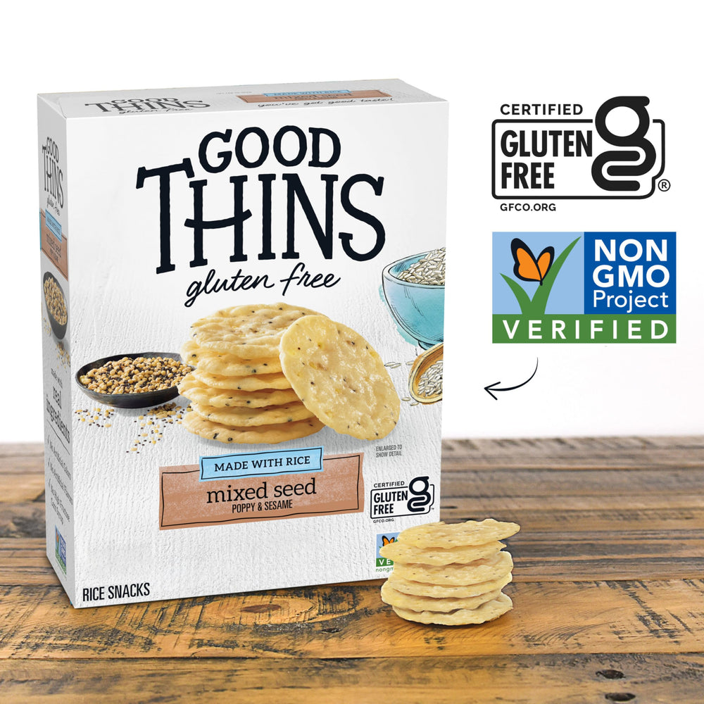 Good Thins crackers dipped into hummus showing easy entertaining benefit