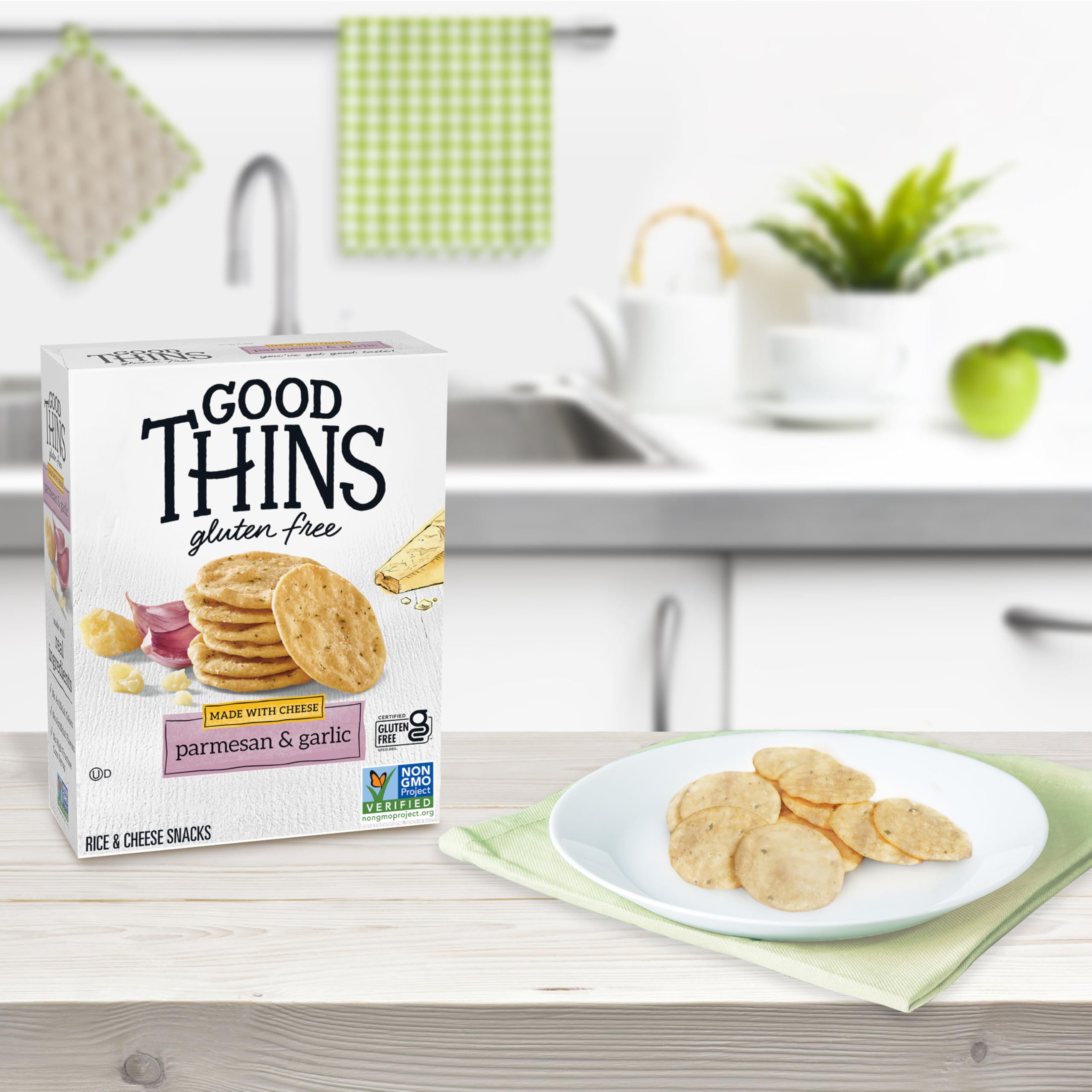 Hand holding Good Thins cracker comparing size and portion control benefit