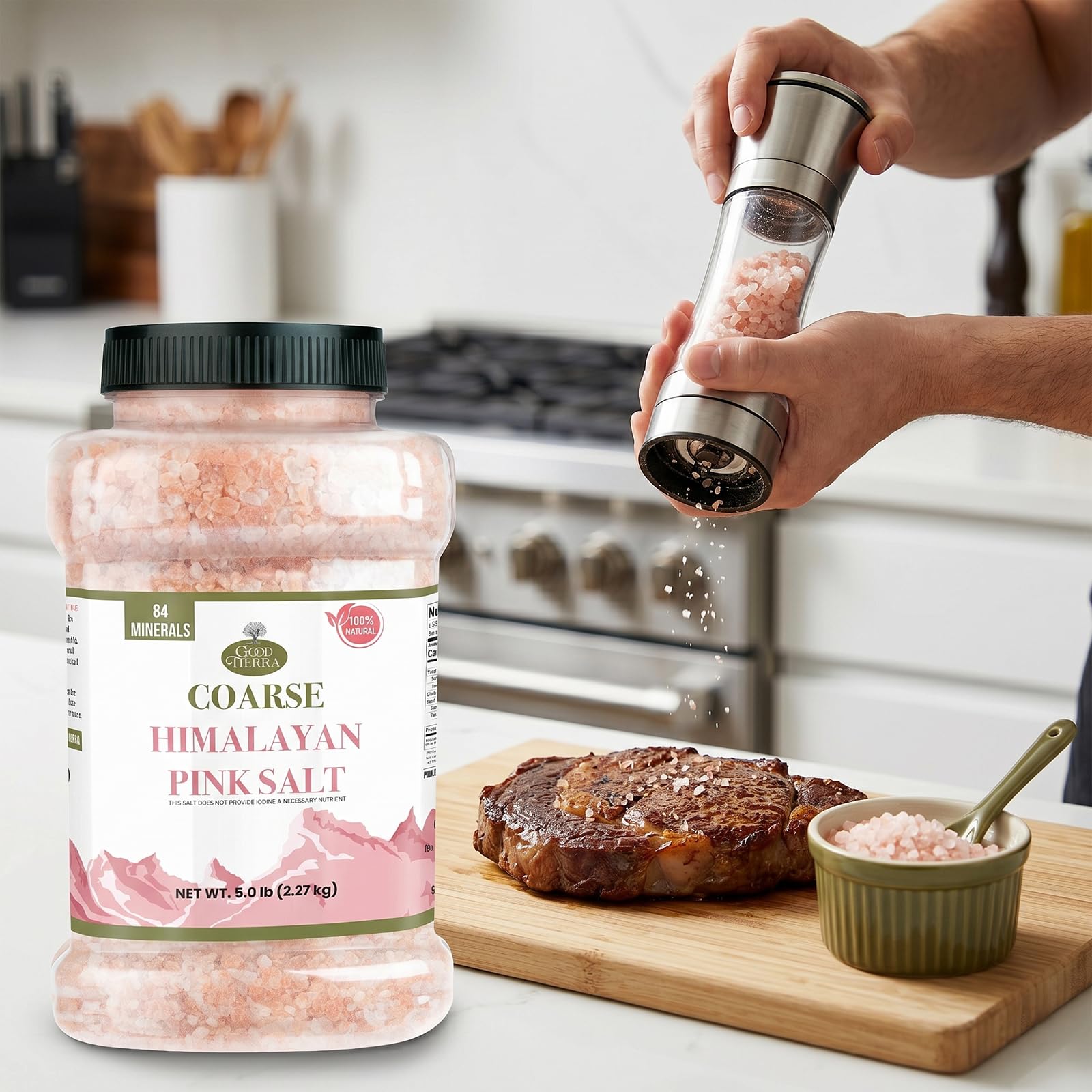 Good Tierra jar on kitchen counter beside herbs and steak illustrating seasoning use