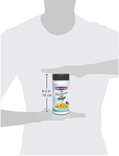 Gourmet Fries Seasonings shaker in use adding tangy flavor to hot fries