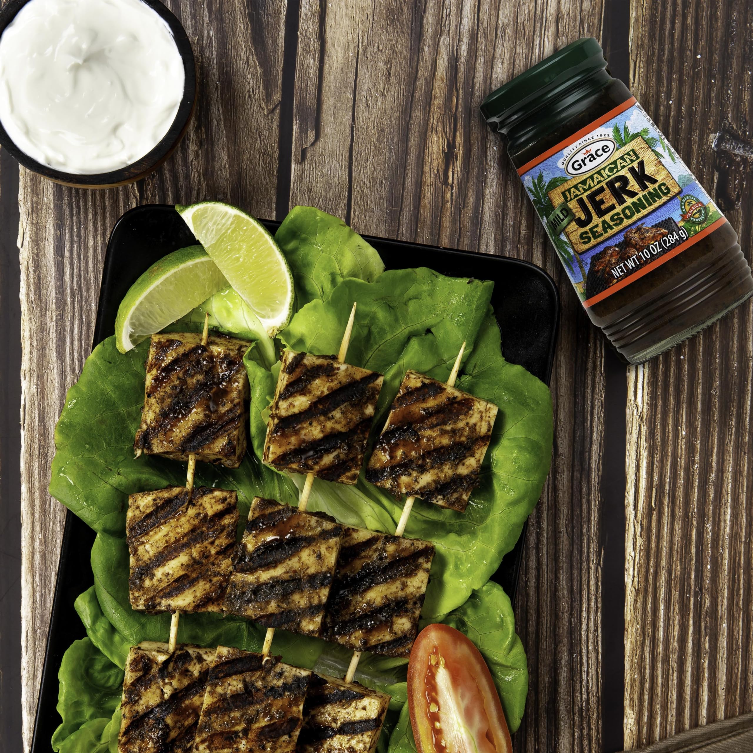 Grilled chicken coated in Grace seasoning demonstrating smoky, charred results