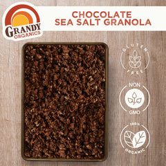 GrandyOats spoon pouring granola over yogurt demonstrating easy topping