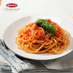 Granoro cooked bucatini in bowl with tomato sauce demonstrating hearty, saucy bite