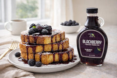 Green Jay Gourmet syrup on a spoon showing thick fruit texture and gloss