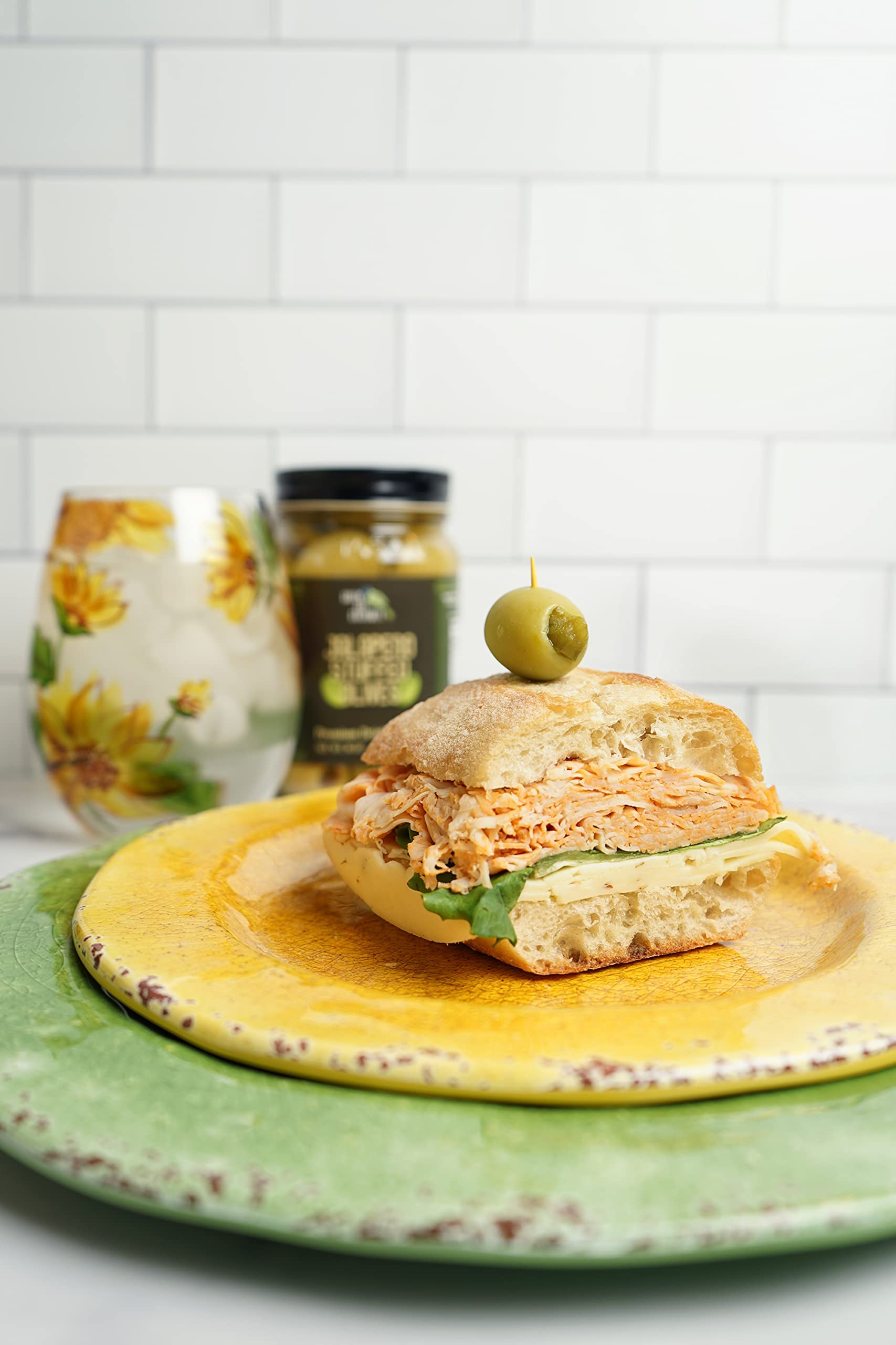 cheese board with olives and cheeses showing Green Jay Gourmet adding savory contrast
