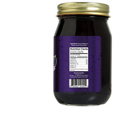 Green Jay Gourmet open jar with spoon showing smooth seedless blackberry texture for easy spreading