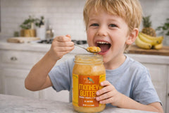 Green Jay Gourmet open jar beside banana pineapple mango illustrating real fruit ingredients
