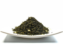 Close-up of Greenhilltea loose jasmine-sprinkled leaves showing texture and quality