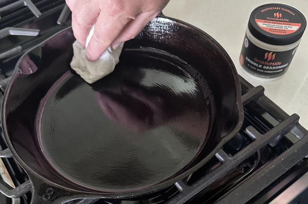 GriddleMATe being rubbed onto a Blackstone flat top demonstrating even application benefit