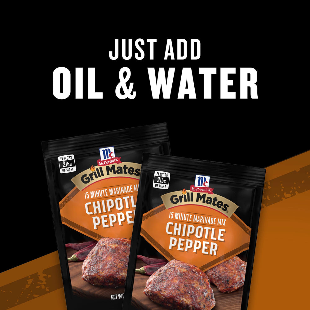 Hand holding Grill Mates packet to show compact single-use serving size