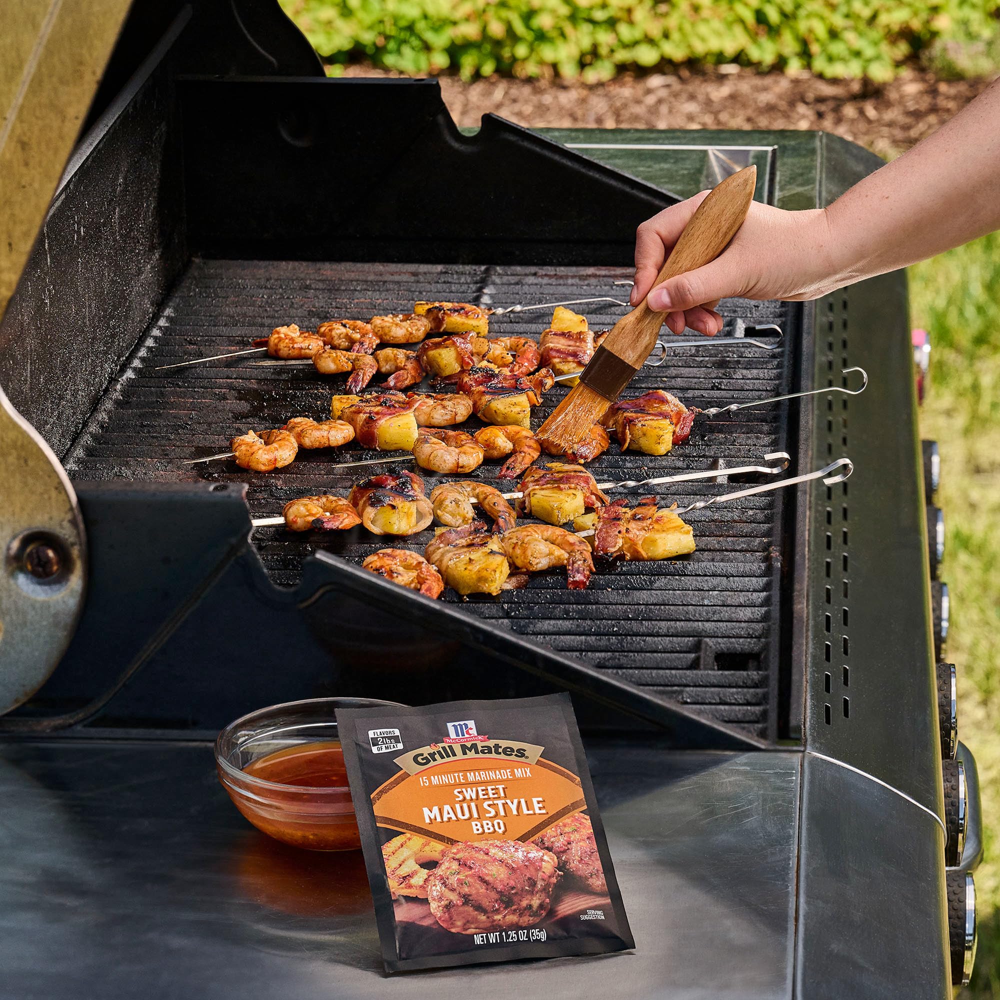 Grill Mates packet beside two-pound chicken to show portion and marinating scale