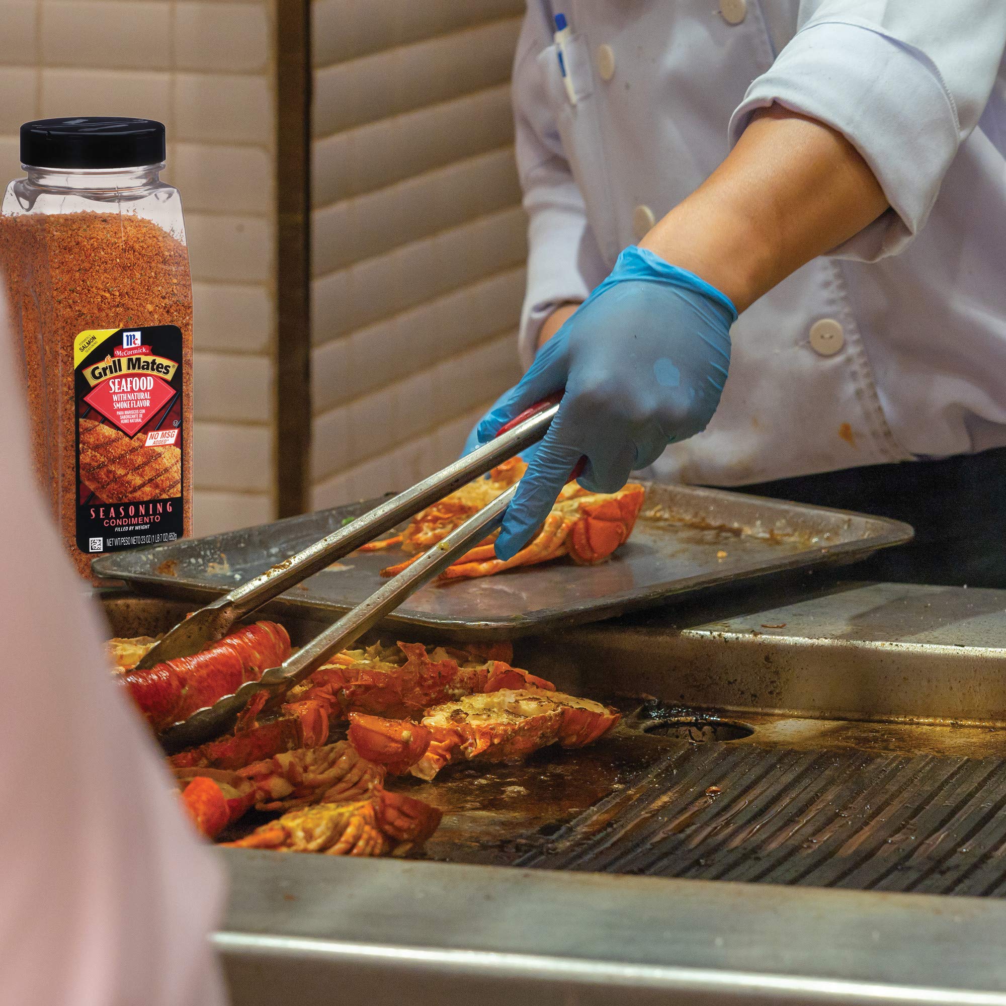 Grill Mates seasoning on salmon fillet on grill, enhances smoky cedar flavor while cooking