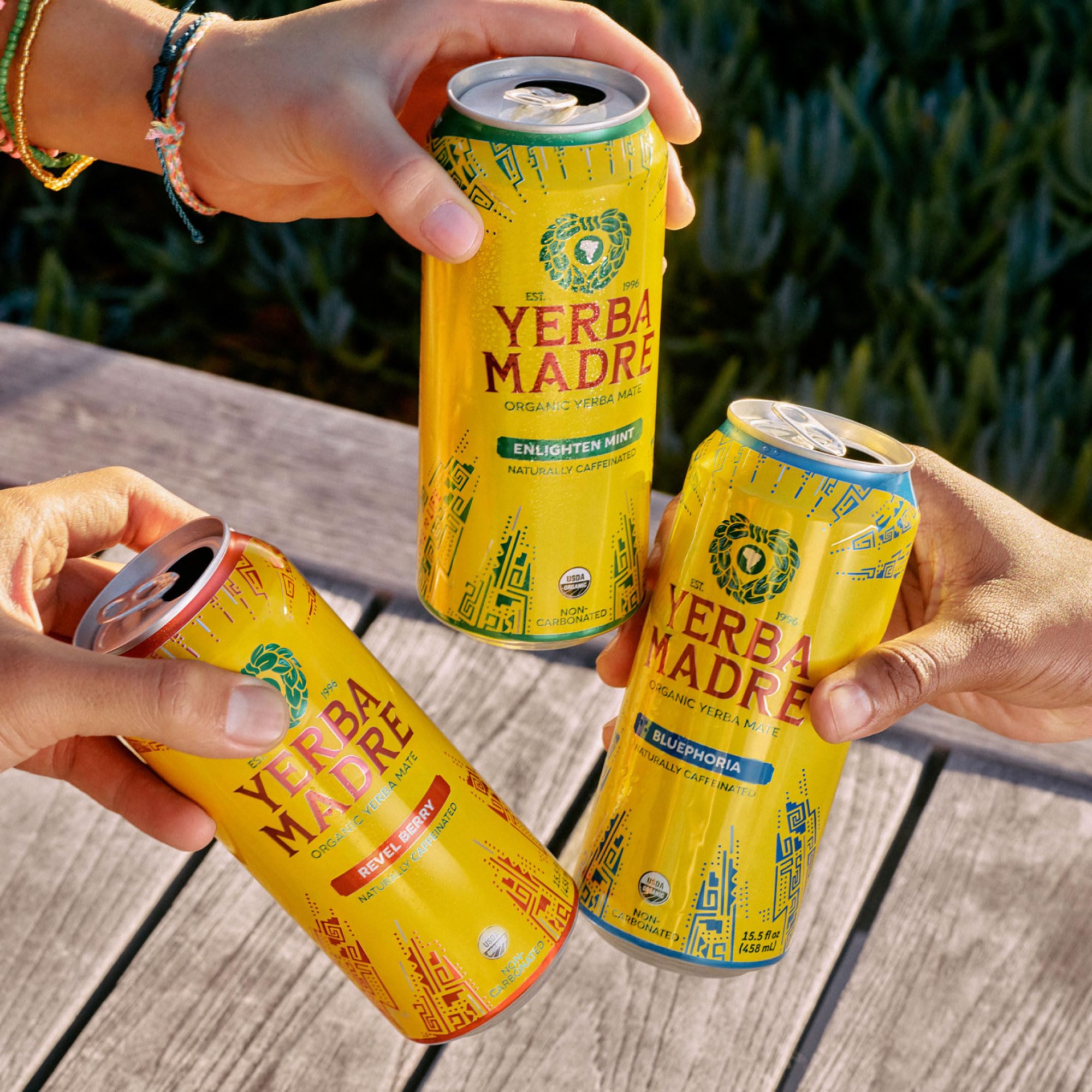 Guayaki cans shared outdoors illustrating community and regenerative sourcing benefit