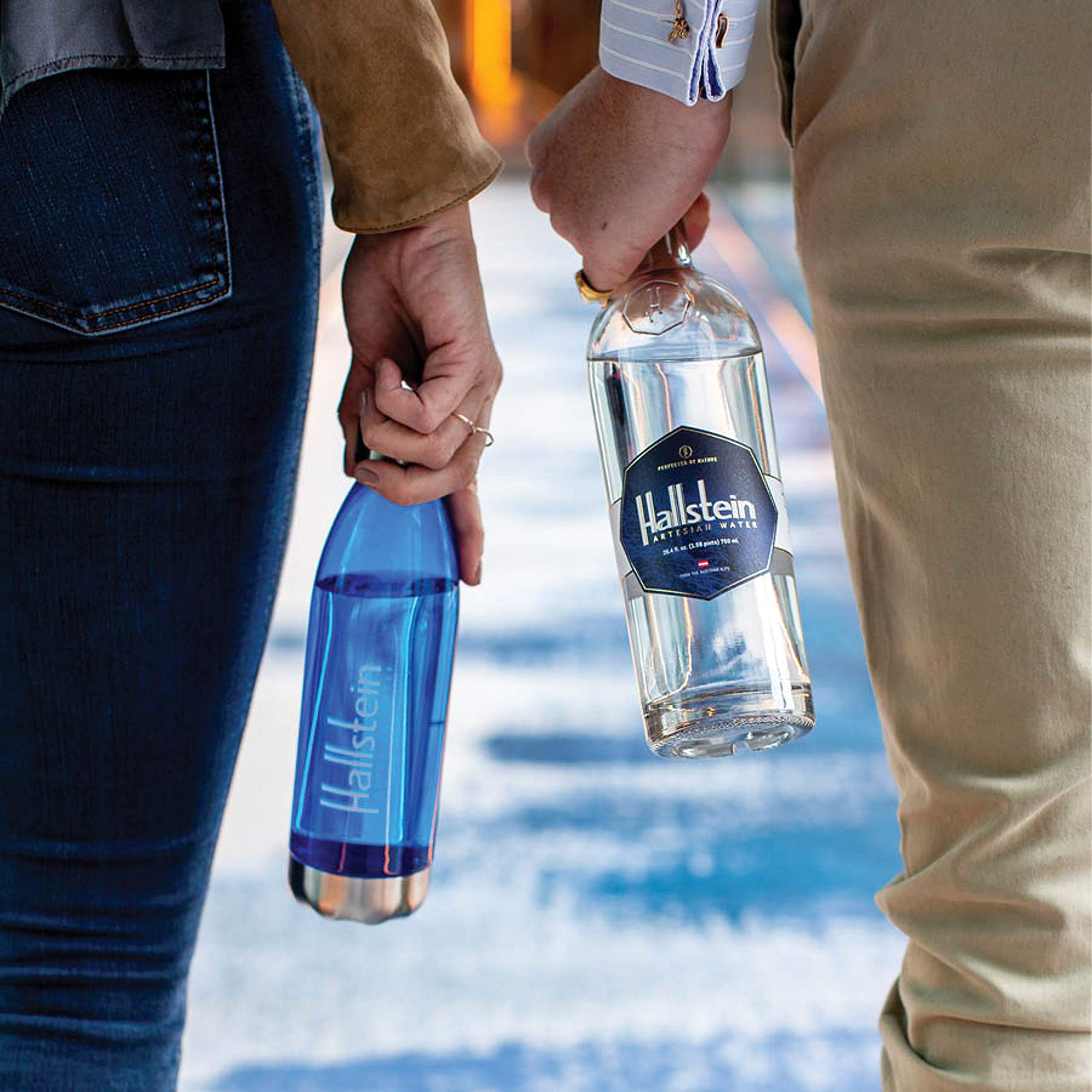 Hand holding Hallstein bottle for scale conveying convenient size and portability