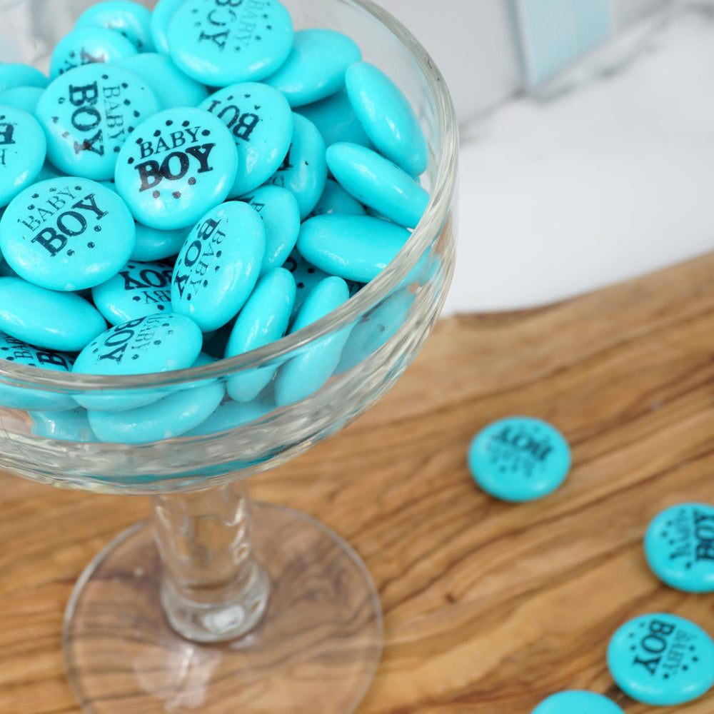 THE HAMPTON CANDY COMPANY hand holding a few gum buttons for scale, demonstrates snack-sized pieces