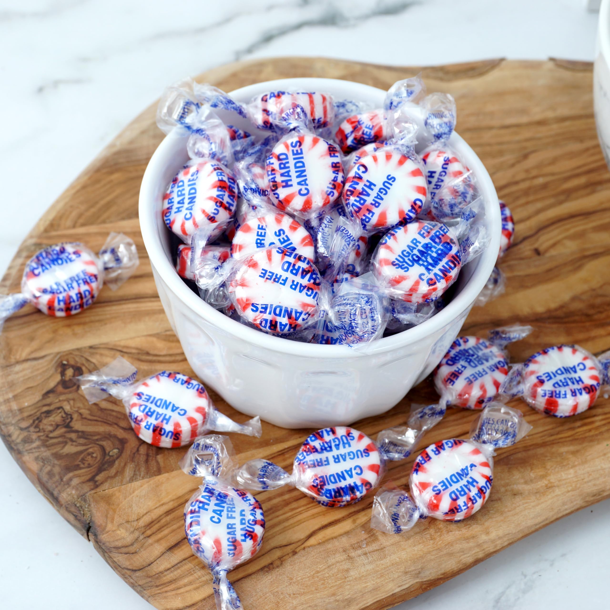 THE HAMPTON CANDY COMPANY mint next to a hand for scale, demonstrates size and portion clarity
