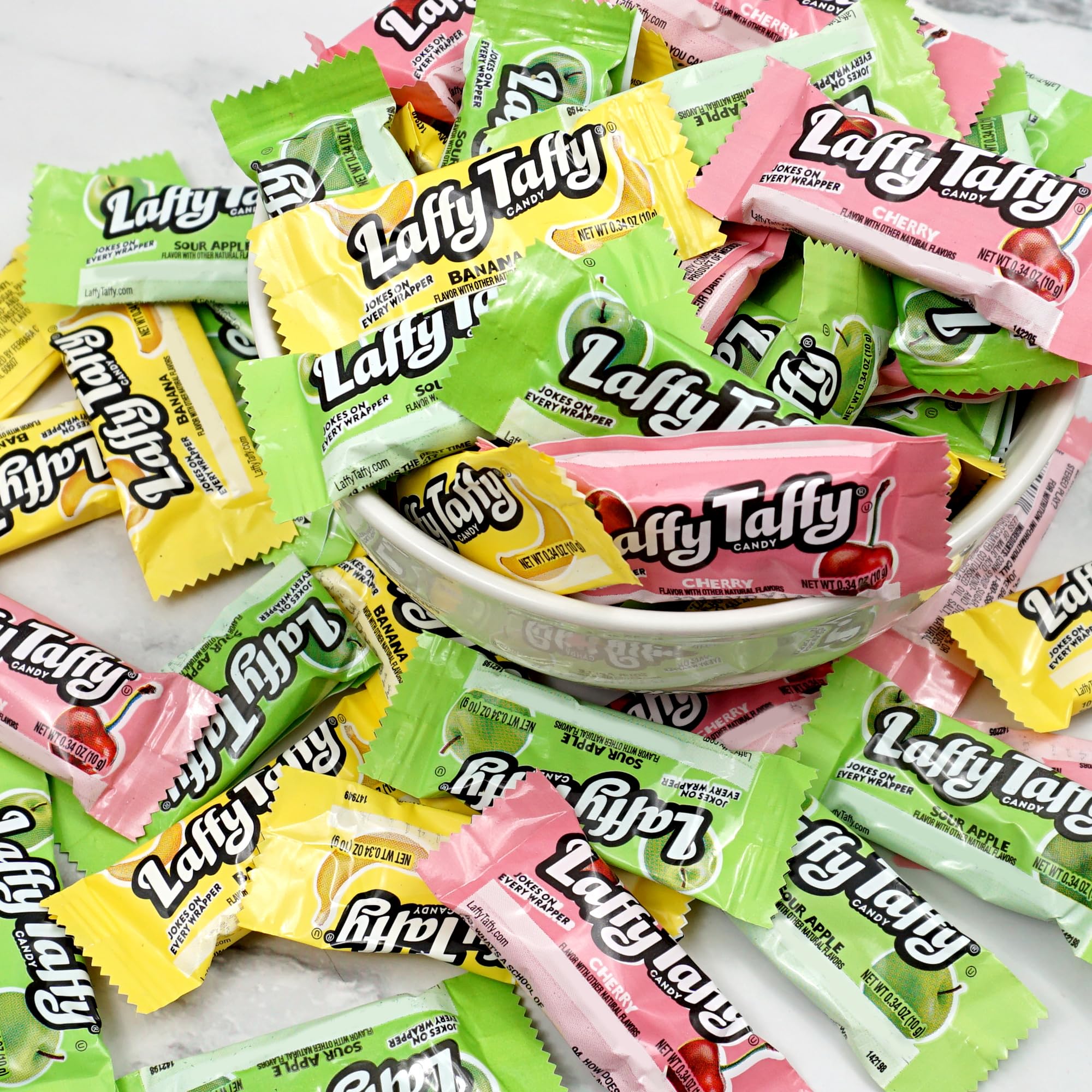 Hand holding a Laffy Taffy piece from The Hampton Popcorn Company indicating portion size and portability
