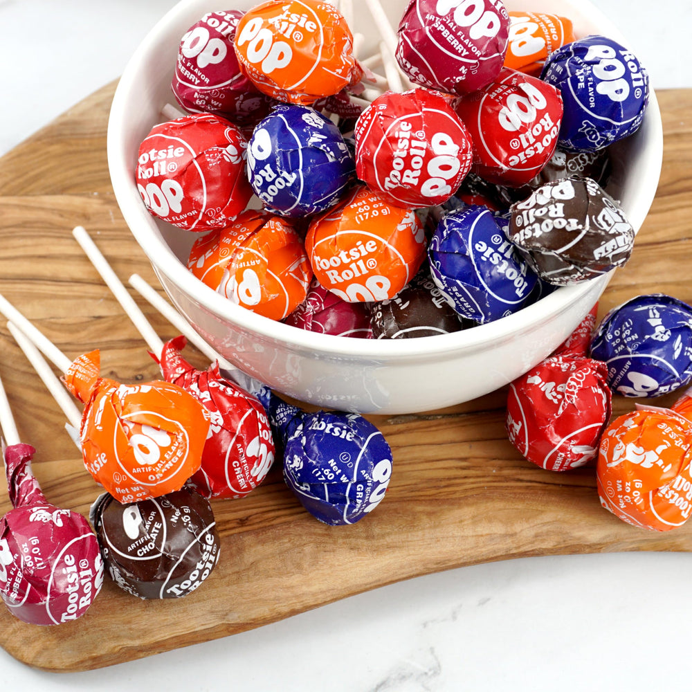 Unwrapped Tootsie Roll Pops displayed by flavor showing variety and easy grabbing benefit