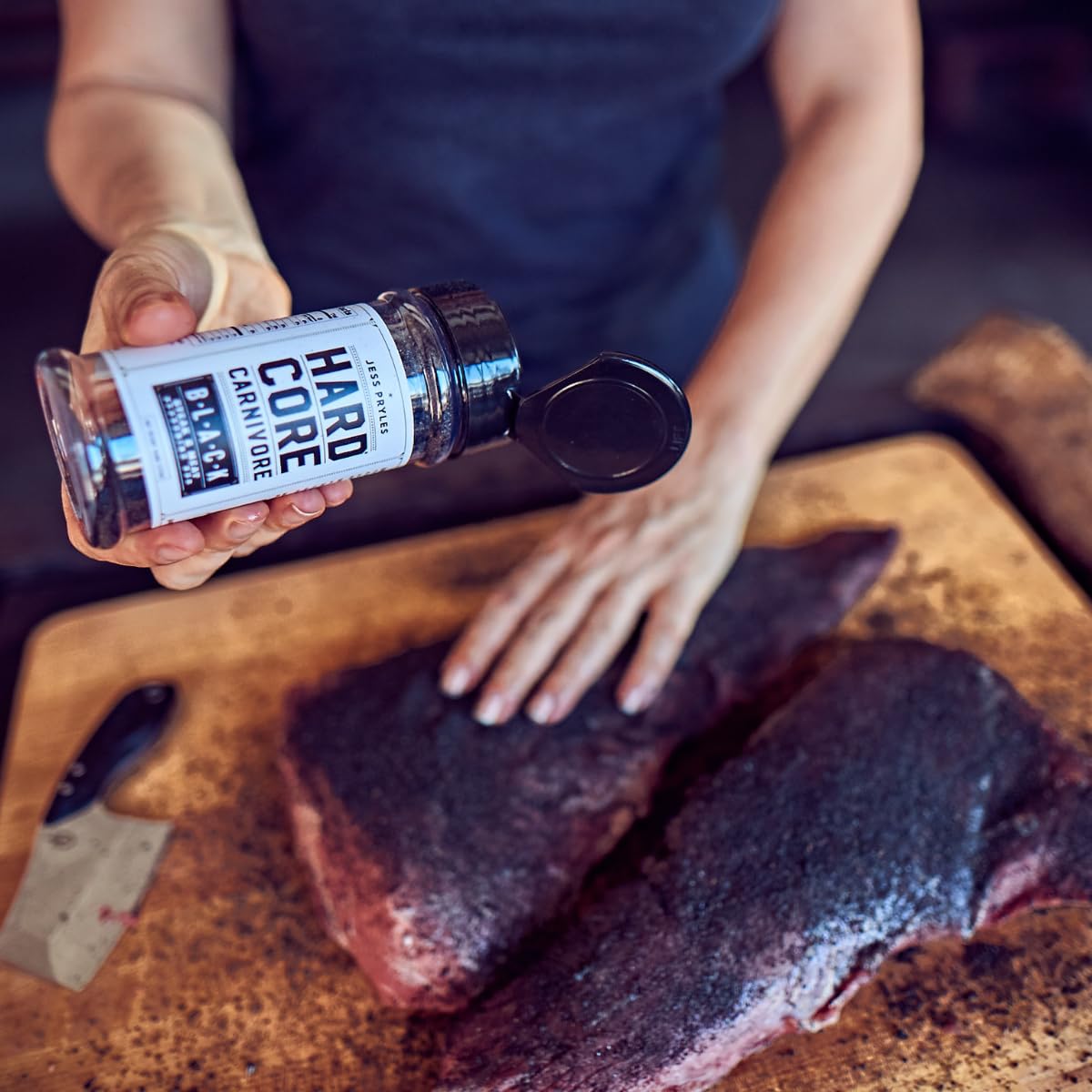 Hardcore Carnivore shaker at backyard grill scene showing real-world use for pitmaster convenience