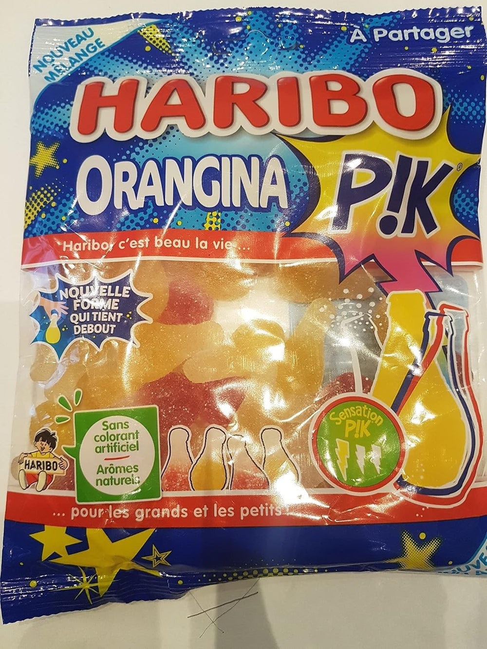 Haribo front packaging showing bottle-shaped orange gummies and bright colors, appealing display