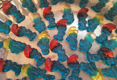 HARIBO Smurfs next to a hand for scale demonstrating petite size and snackable portion