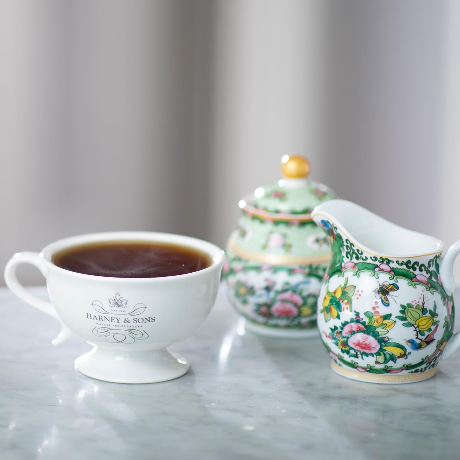 Harney & Sons tin beside teacup for scale showing compact giftable size