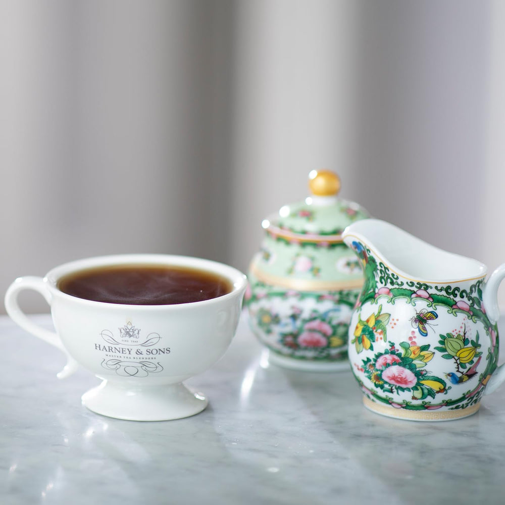Harney & Sons tin beside teacup for scale showing compact giftable size