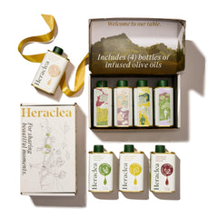 Heraclea gift box front packaging showing four infused olive oil bottles and branding benefit