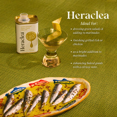 Heraclea drizzling lemon olive oil onto fresh bread to enhance flavor