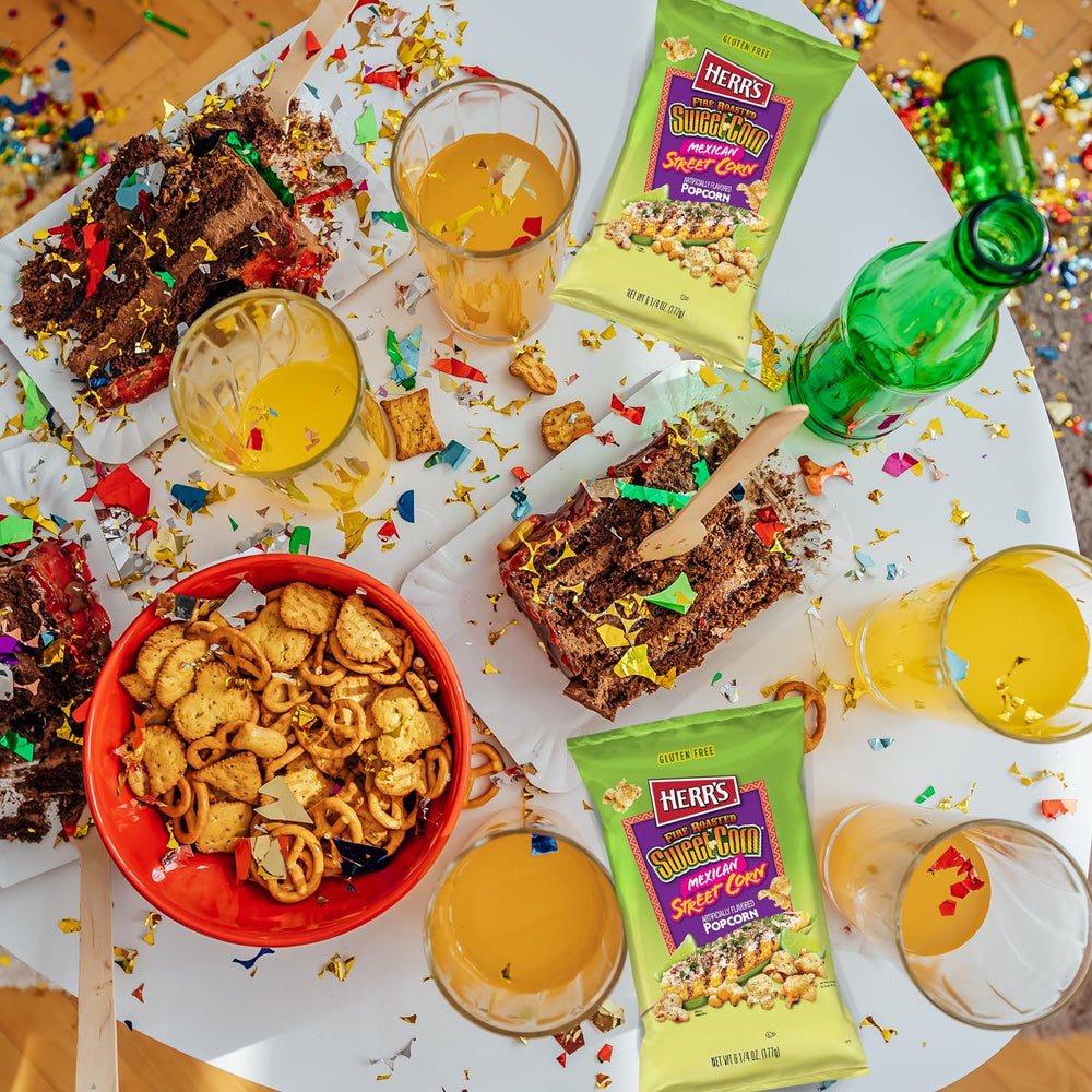 Lifestyle shot of Herr's popcorn on a party spread showing crowd-pleasing appeal